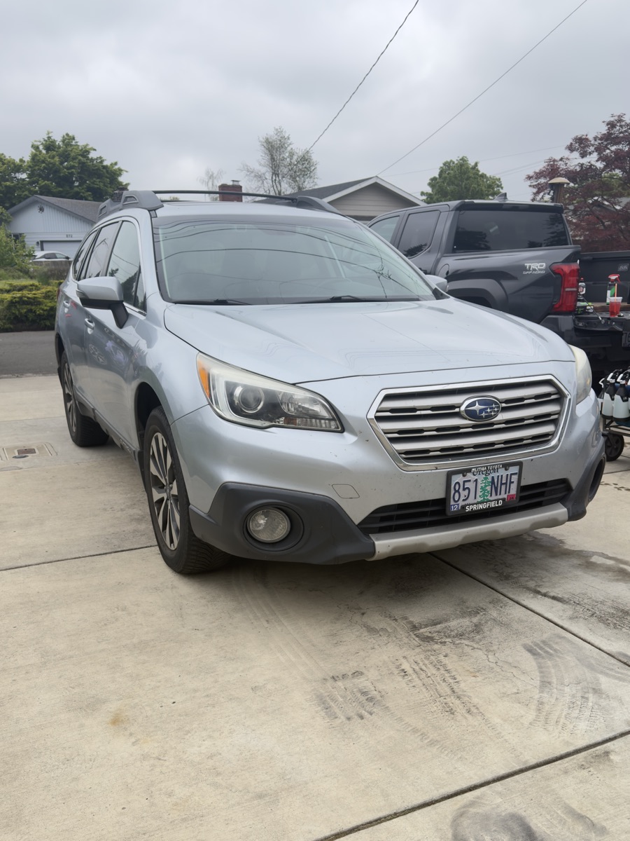 Silver Subaru Outback before detail, dull paint, dirty wheels