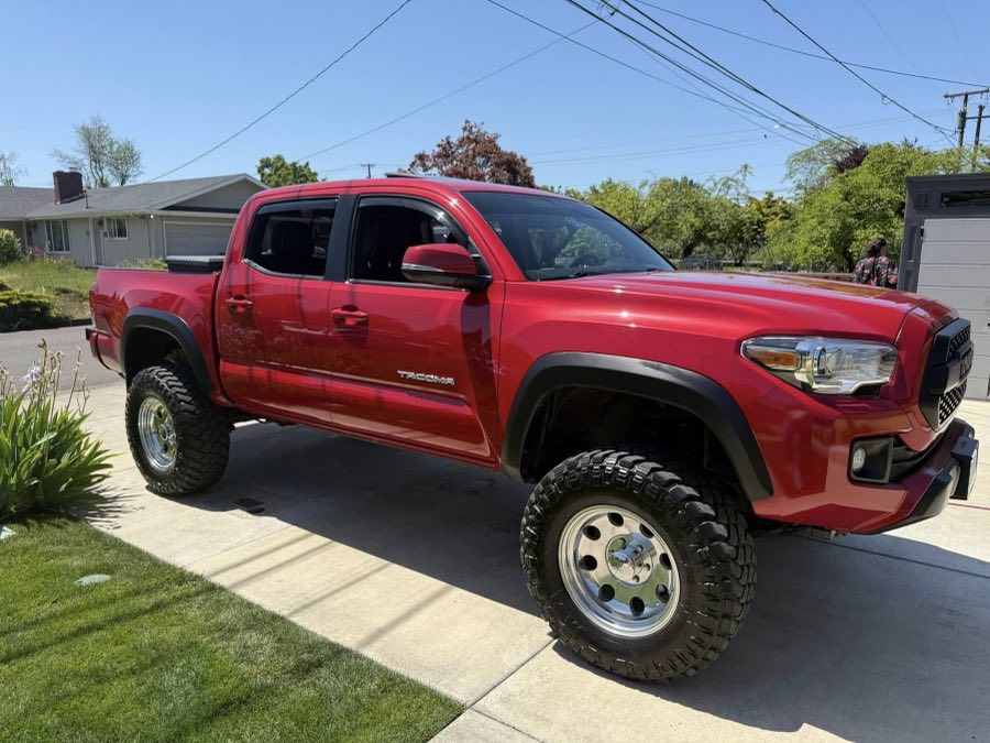 Lifted red Tacoma finished after a full mobile detail in a Springfield driveway