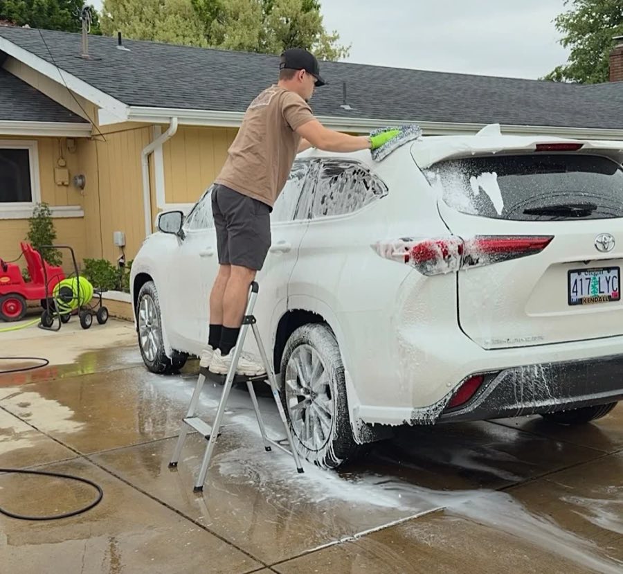 Foam wash reaching the roof of a tall truck on a Junction City driveway